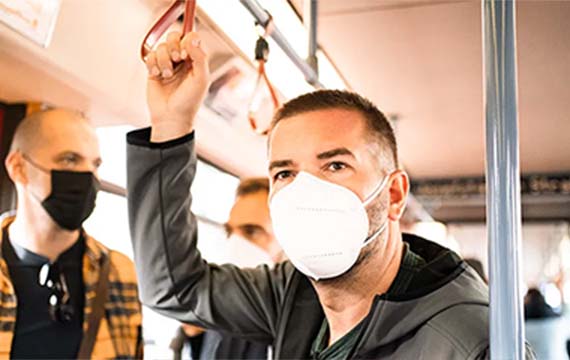 Man wearing a face mask taking public transit