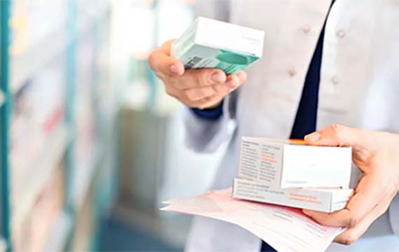 Pharmacist holding prescriptions