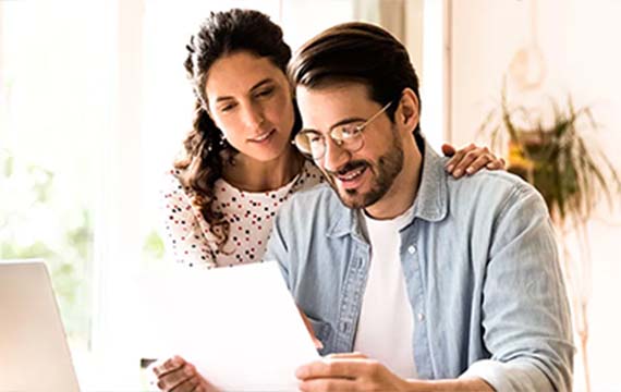 Couple review a document at home together