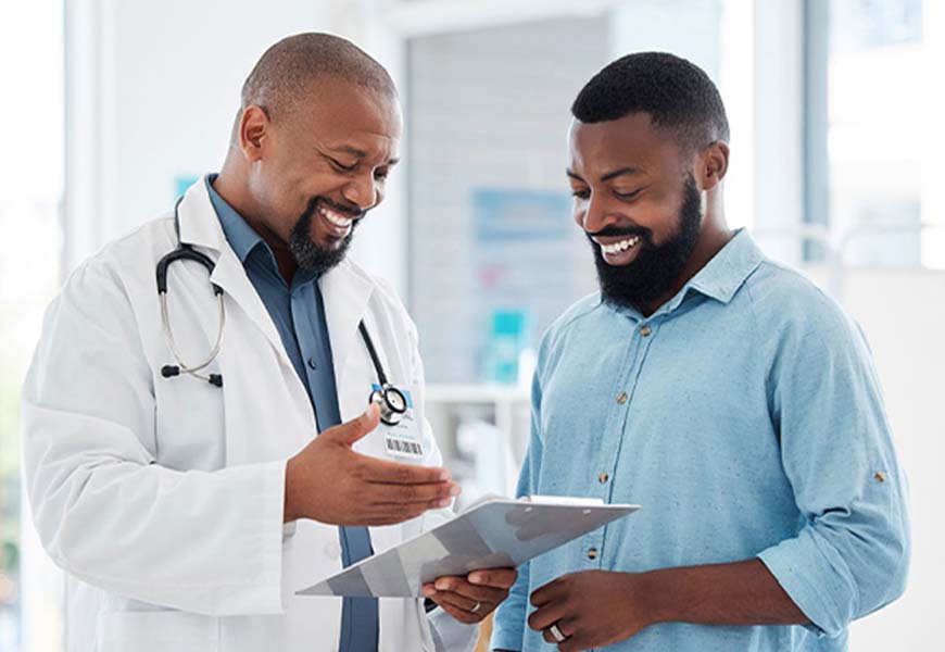 Man happily speaking to his doctor about good results