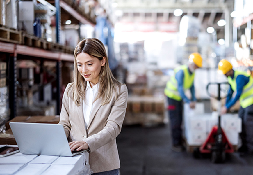 Female manager using her laptop at the warehouse