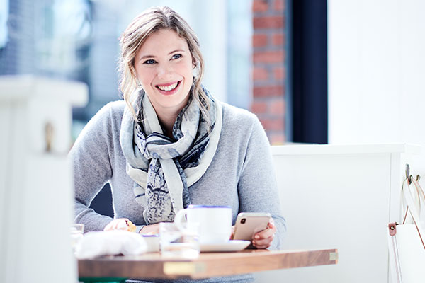 Woman drinking coffee at cafe